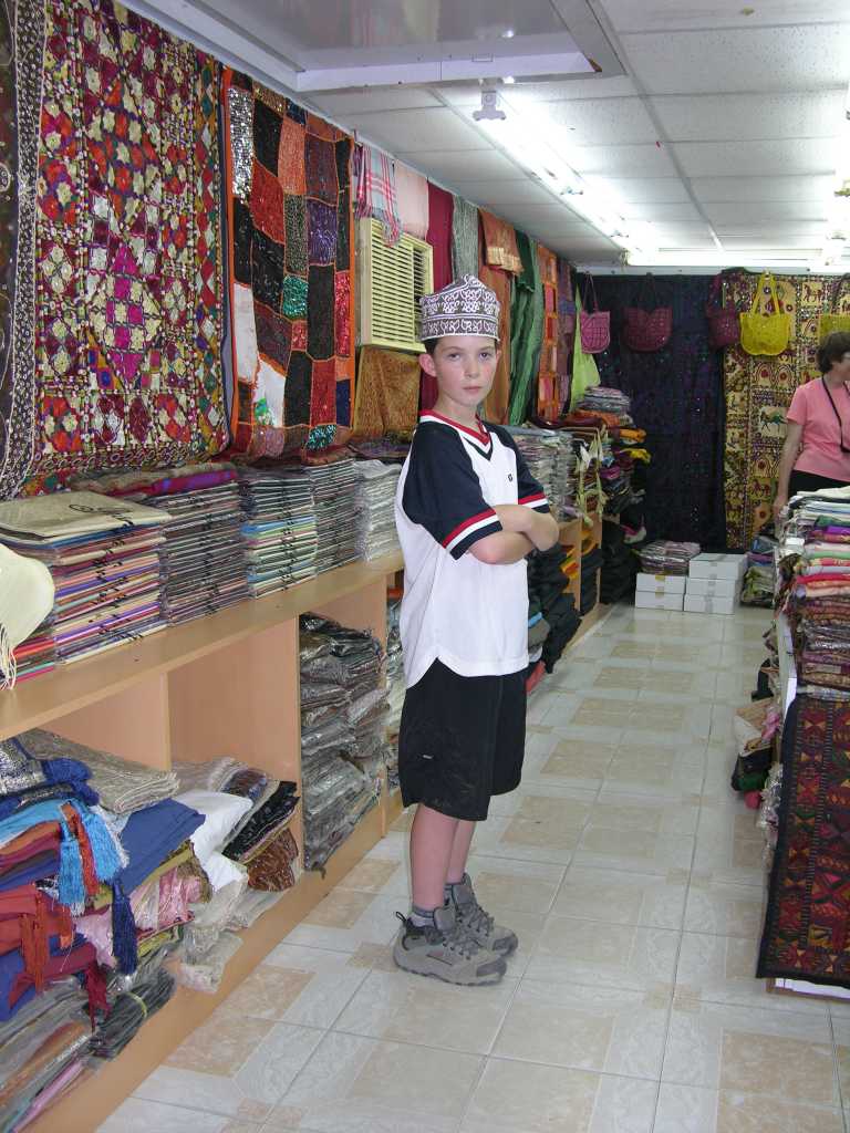 Muscat 03 Mutrah 07 Souq Store The Mutrah Souq retains the chaotic interest of a traditional Arab market, although housed under modern barasti (palm-leaf) roofing. Peter bought a traditional hat.